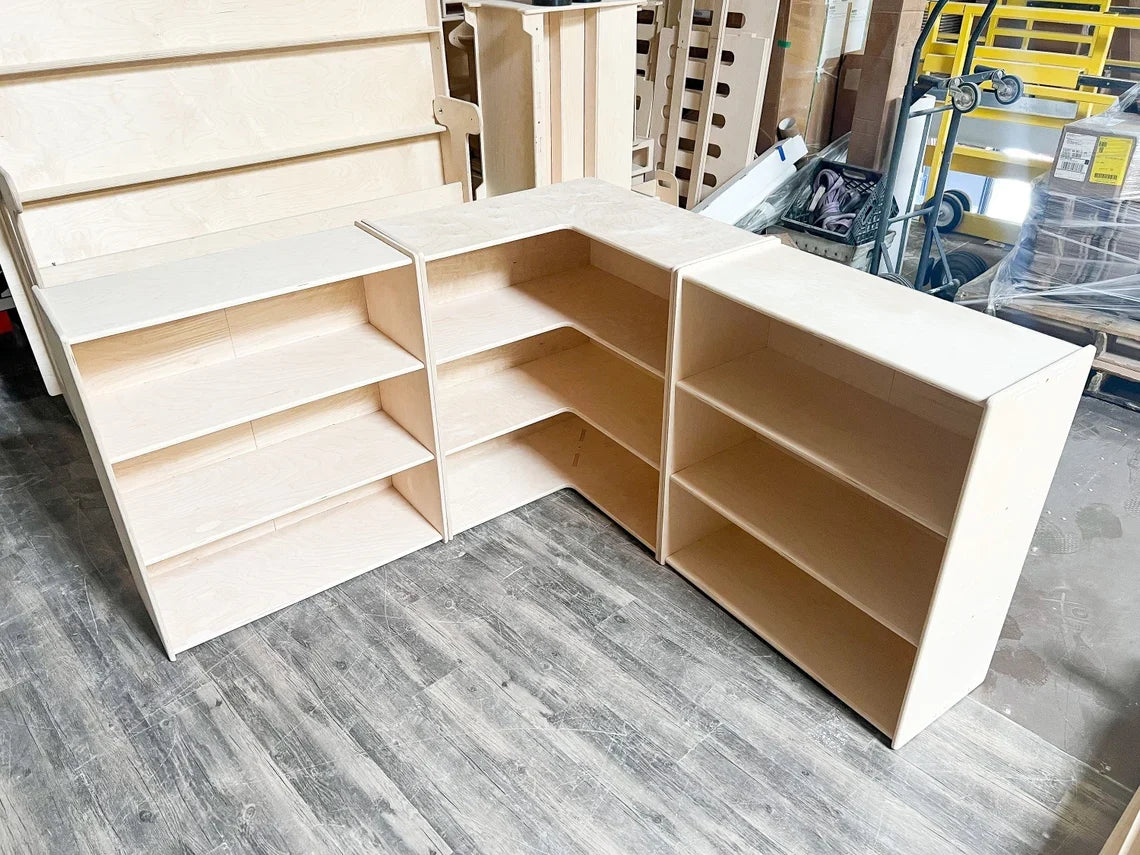 Unfinished Baltic birch Jared corner shelf set assembled in a workshop